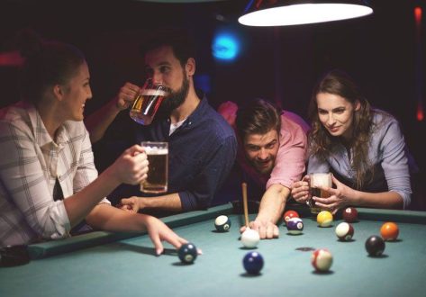 close-up-young-friends-having-fun-while-playing-pool-game